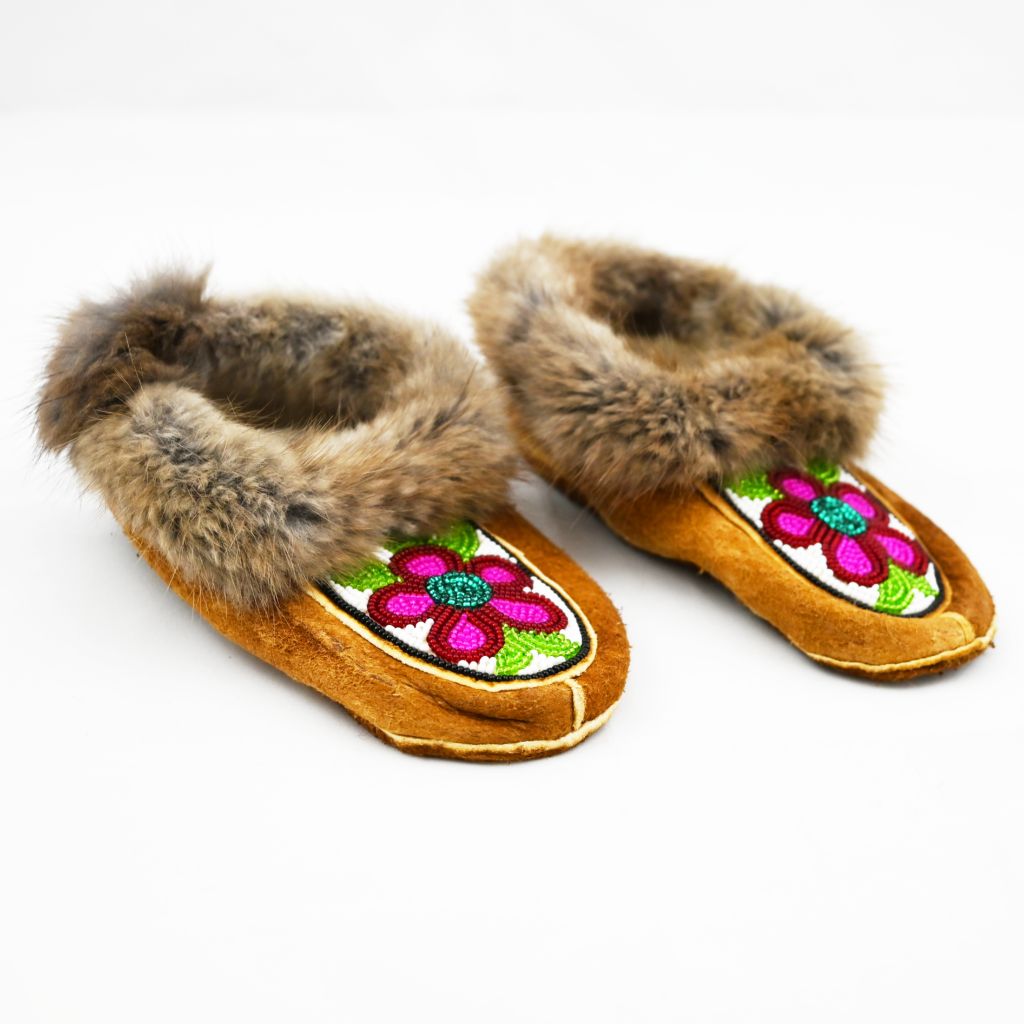 Beaded children's moccasins. Muskrat trim, home tan elk hide, beadwork and fleece. Beaded pink flowers and fur trim.